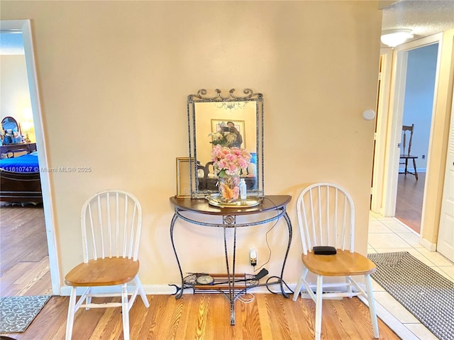 dining space with baseboards and wood finished floors