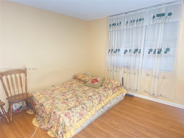 bedroom with hardwood / wood-style flooring