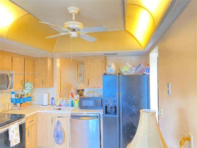 kitchen featuring a sink, a ceiling fan, light countertops, appliances with stainless steel finishes, and light brown cabinetry