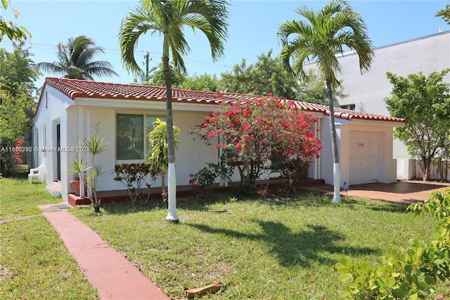 view of front of property with a garage and a front yard