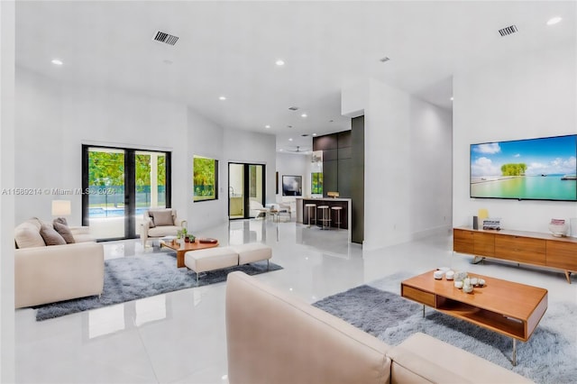 living room featuring a high ceiling and french doors