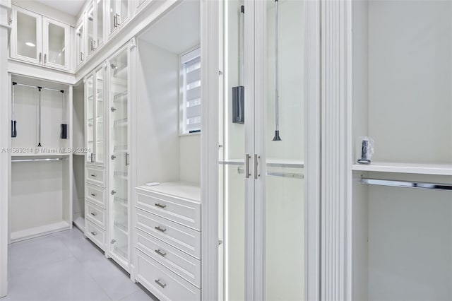 spacious closet with light tile patterned floors