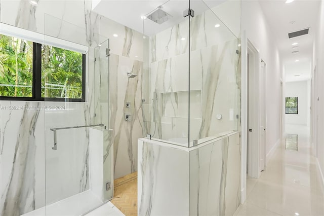 bathroom with a shower with door