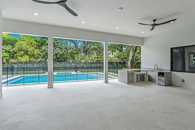 exterior space featuring ceiling fan, area for grilling, sink, and a patio