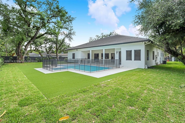 view of swimming pool featuring a patio and a lawn