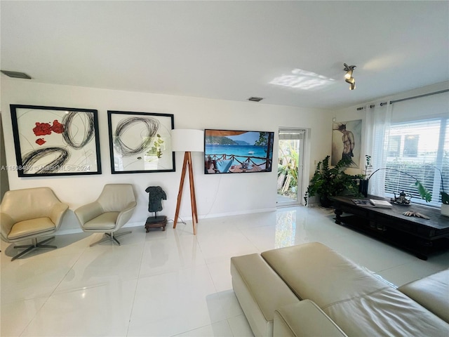 tiled living room with plenty of natural light