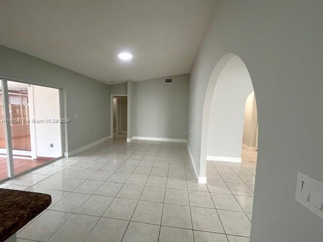 spare room featuring light tile flooring