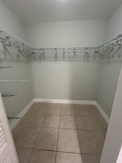 spacious closet featuring tile flooring