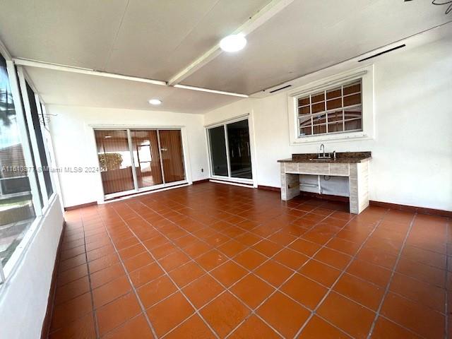 unfurnished living room featuring dark tile floors