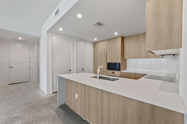 kitchen with wall oven, black electric stovetop, kitchen peninsula, light brown cabinets, and sink