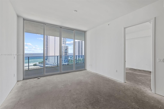 empty room featuring a wall of windows and a water view