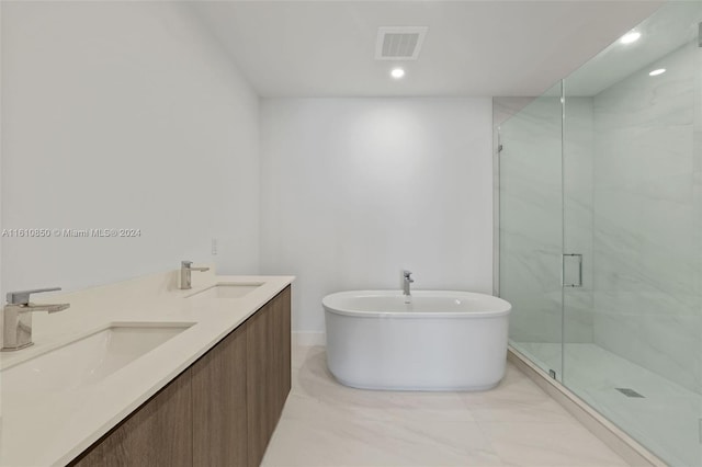 bathroom featuring independent shower and bath and vanity