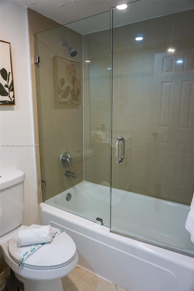 full bathroom featuring recessed lighting, toilet, tile patterned flooring, and shower / bath combination with glass door