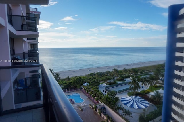 balcony featuring a beach view and a water view