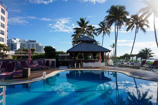 pool featuring a gazebo, a patio area, and fence
