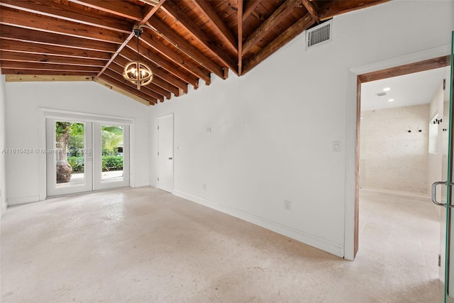 empty room featuring concrete floors, an inviting chandelier, french doors, and lofted ceiling