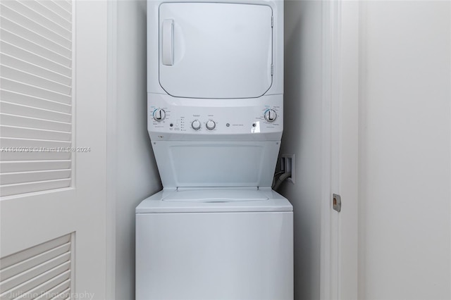 laundry area featuring stacked washer / dryer and washer hookup