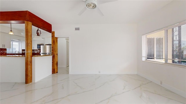 empty room featuring ceiling fan and sink