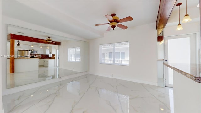 unfurnished room featuring ceiling fan