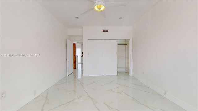 unfurnished bedroom featuring ceiling fan and a closet