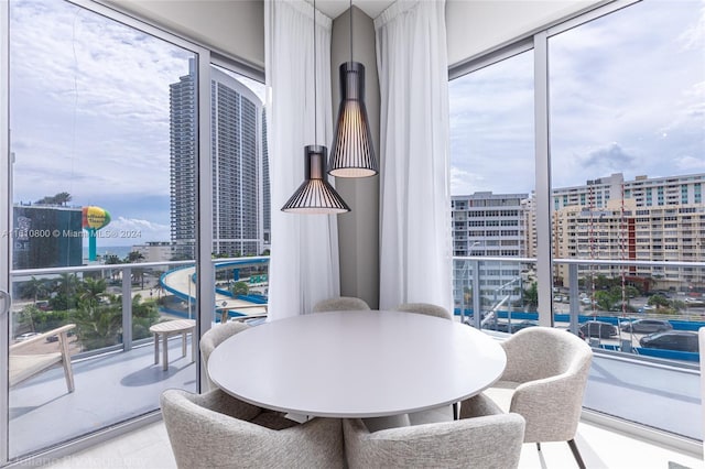 dining space featuring floor to ceiling windows