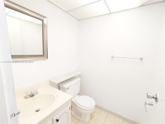 bathroom featuring vanity, tile patterned floors, and toilet