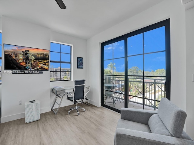 office with a wealth of natural light, baseboards, and wood finished floors