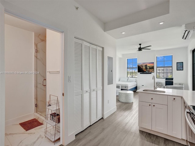 interior space with a stall shower, a closet, electric panel, and an AC wall unit