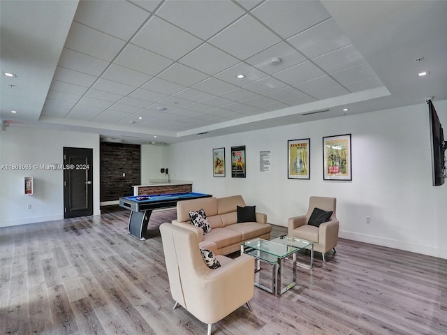 living room featuring billiards, baseboards, wood finished floors, a tray ceiling, and recessed lighting