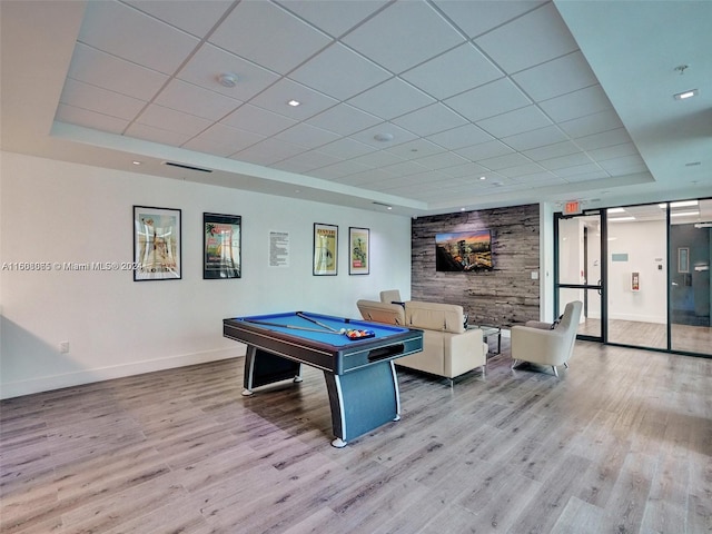 playroom featuring a barn door, wood finished floors, a drop ceiling, billiards, and baseboards