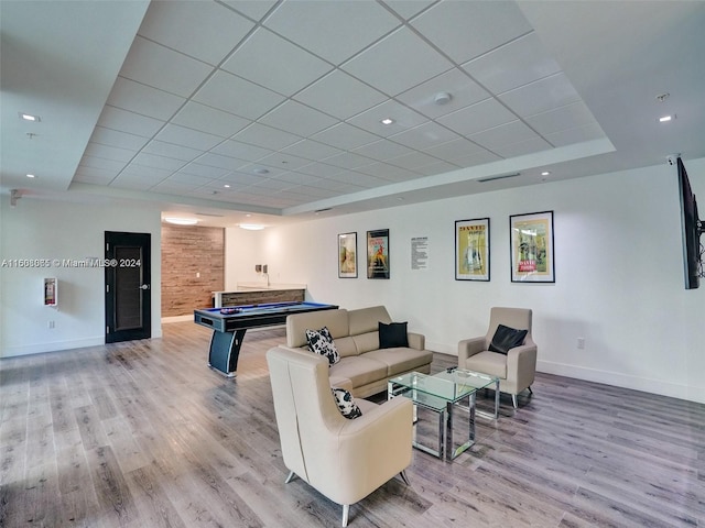 playroom with billiards, baseboards, visible vents, wood finished floors, and a tray ceiling