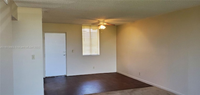 empty room with a textured ceiling and ceiling fan