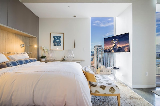 bedroom featuring multiple windows and concrete flooring