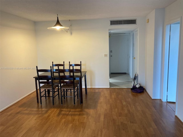 dining space with dark wood-type flooring