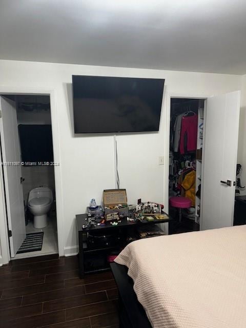 bedroom featuring a closet and dark wood-type flooring