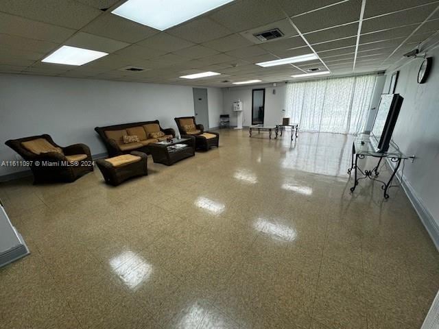 unfurnished living room with a paneled ceiling