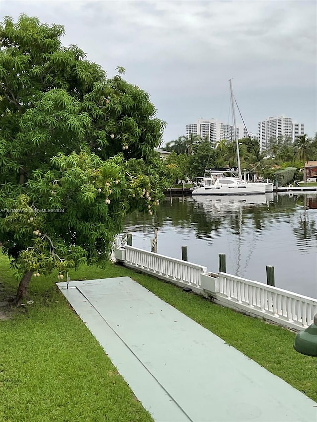 surrounding community featuring a water view and a yard