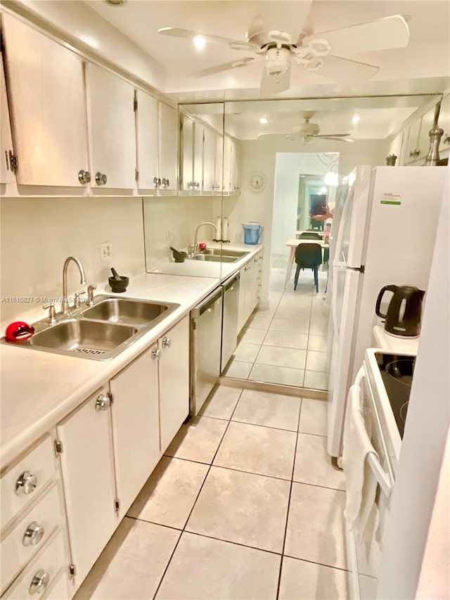 kitchen featuring light tile patterned flooring, white cabinets, pendant lighting, ceiling fan, and sink