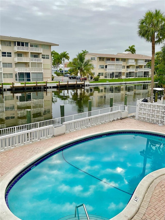 view of pool featuring a water view