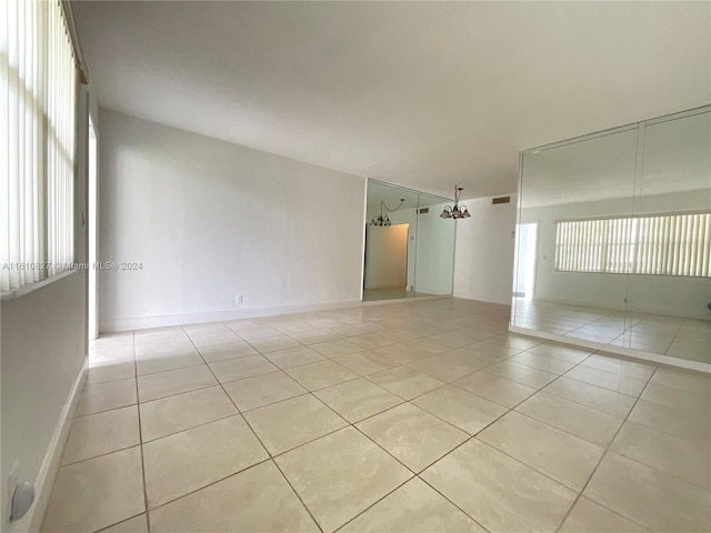 tiled empty room featuring a healthy amount of sunlight