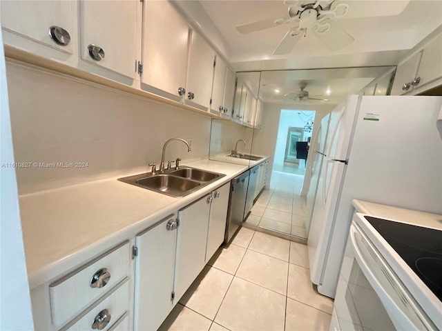 kitchen featuring dishwasher, sink, white cabinets, light tile patterned floors, and ceiling fan