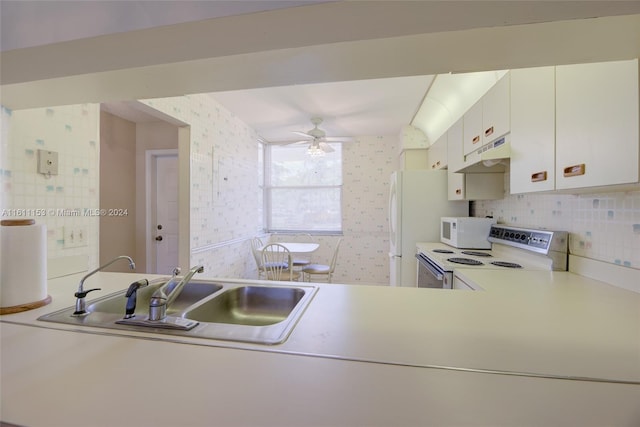 kitchen with white appliances, white cabinetry, decorative backsplash, sink, and ceiling fan