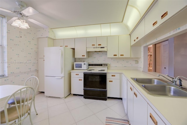 kitchen featuring white appliances, white cabinets, sink, light tile patterned flooring, and ceiling fan