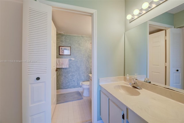 bathroom featuring tile patterned floors, toilet, walk in shower, and vanity