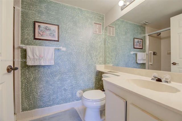 bathroom with vanity, toilet, tile patterned floors, and an enclosed shower