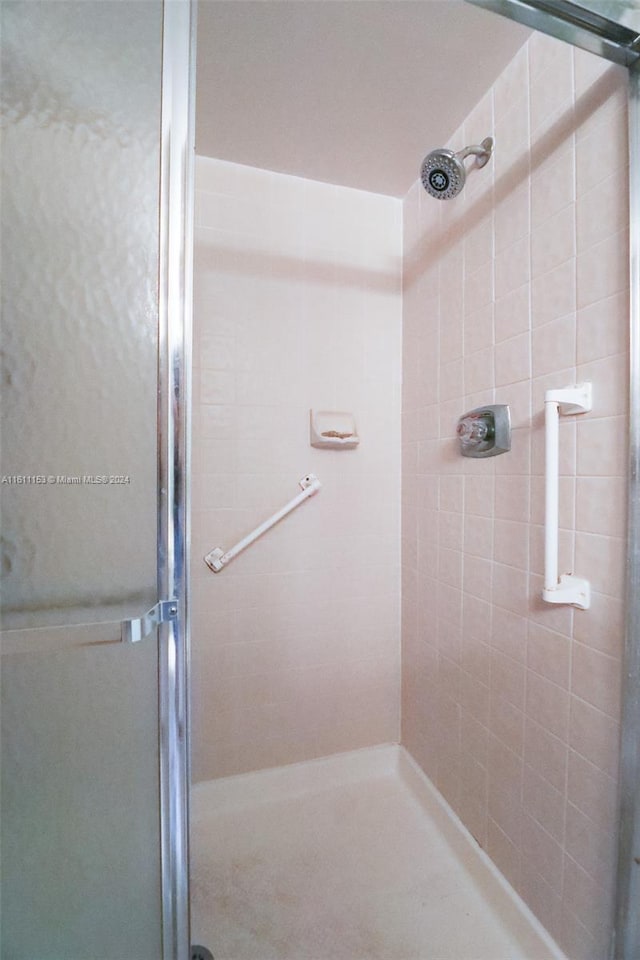 bathroom with a shower with shower door