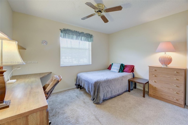 bedroom with ceiling fan and light colored carpet