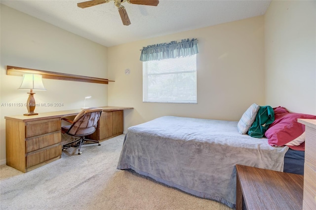 bedroom featuring ceiling fan and light carpet