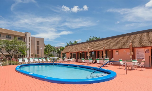 view of swimming pool with a patio