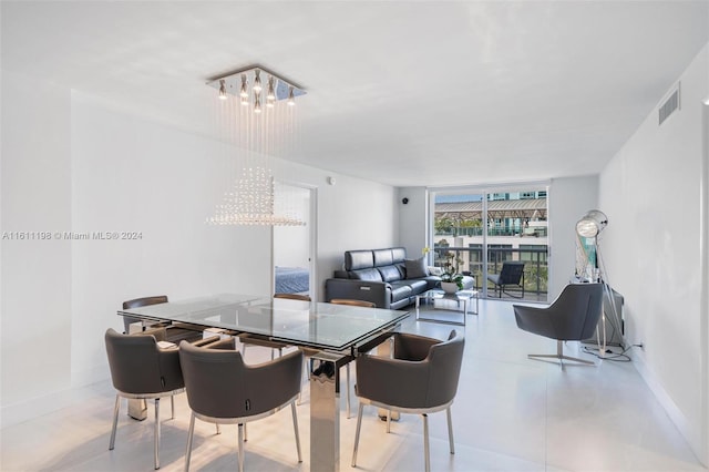 6039 Collins Ave Unit 734, Miami Beach, FL 33140 - dining area with a chandelier and baseboards